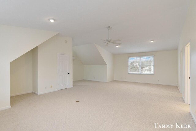 bonus room with ceiling fan, light carpet, and lofted ceiling