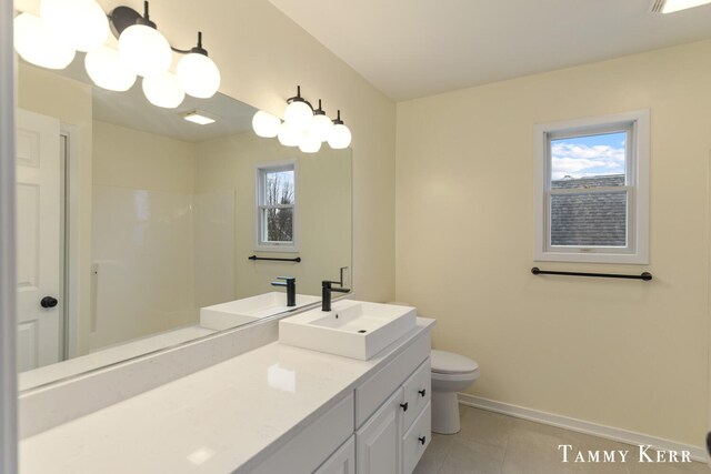 bathroom with tile patterned flooring, a shower, vanity, and toilet