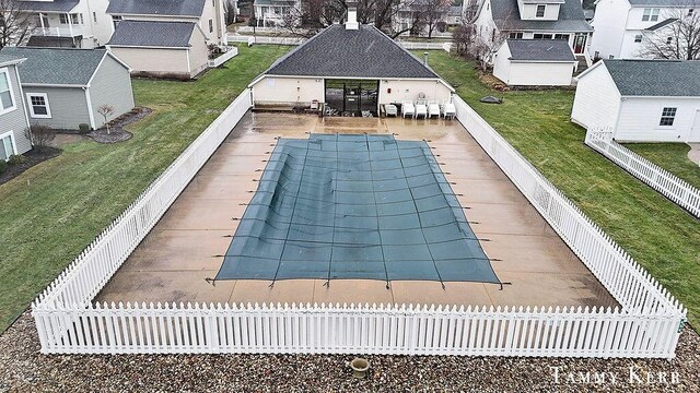 view of swimming pool with exterior bar, a yard, and a patio area