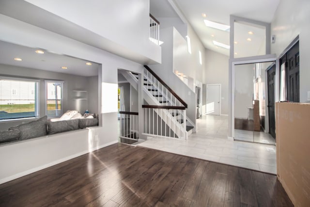 entryway with hardwood / wood-style floors and a skylight