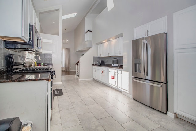 kitchen with stainless steel fridge with ice dispenser, backsplash, white cabinetry, and pendant lighting