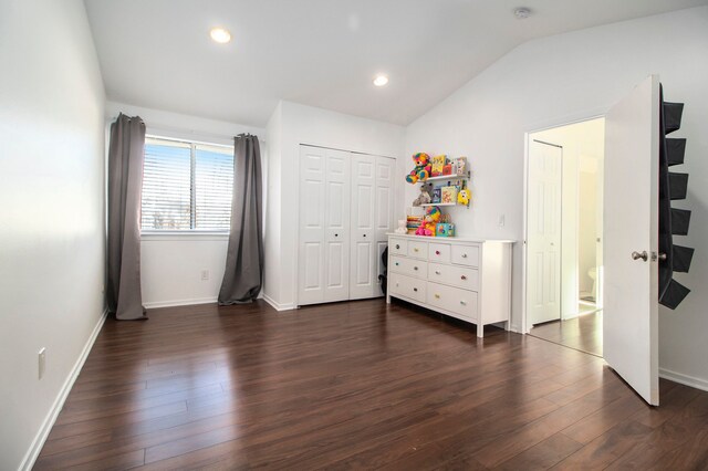 bedroom featuring vaulted ceiling, a closet, and dark wood-type flooring