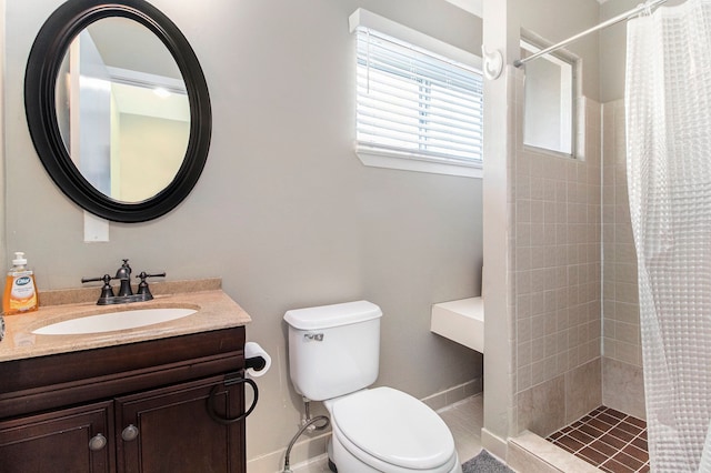 bathroom with vanity, toilet, and curtained shower