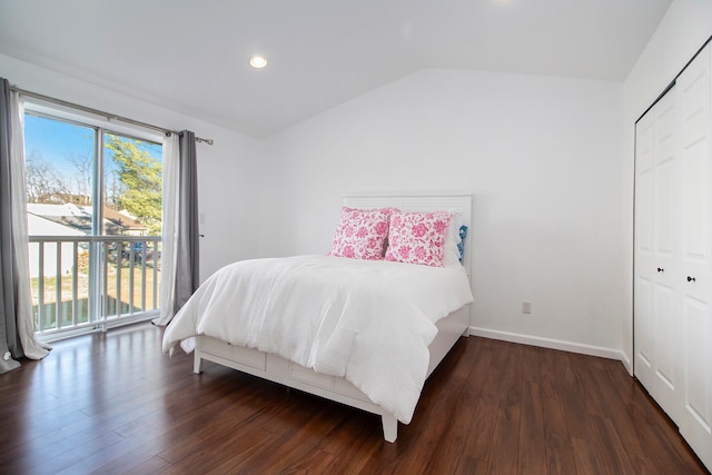 bedroom featuring access to outside, a closet, dark wood-type flooring, and vaulted ceiling