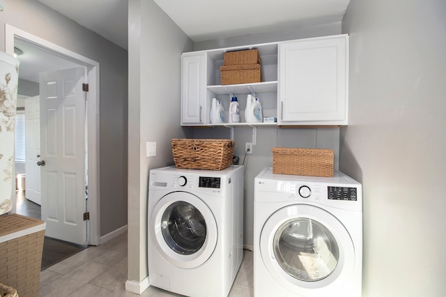 laundry room with cabinets and washer and clothes dryer