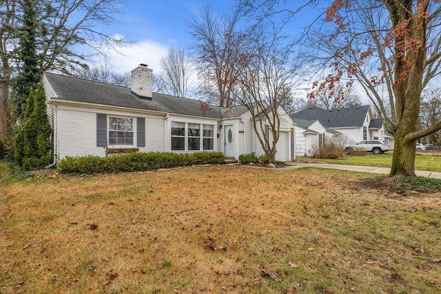 single story home with a garage and a front lawn