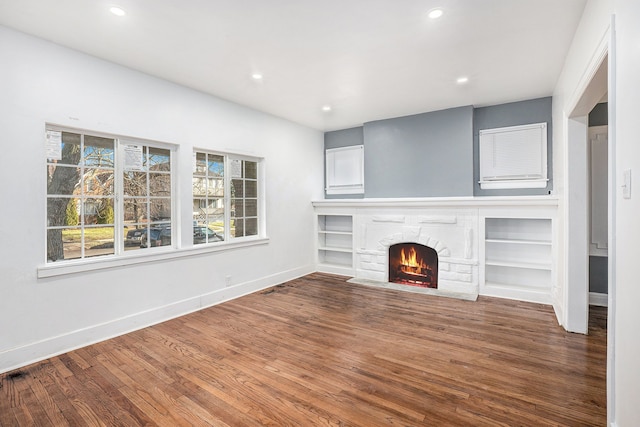 unfurnished living room with wood-type flooring