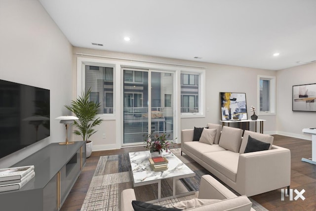 living area with baseboards, dark wood finished floors, and recessed lighting