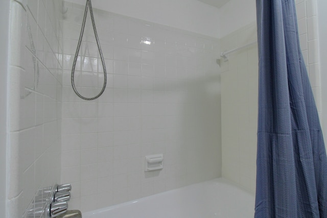 bathroom with shower / bathtub combination with curtain