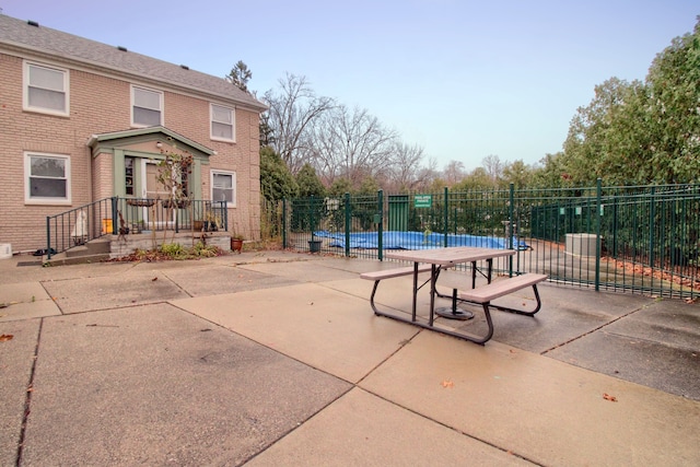 view of patio featuring a covered pool