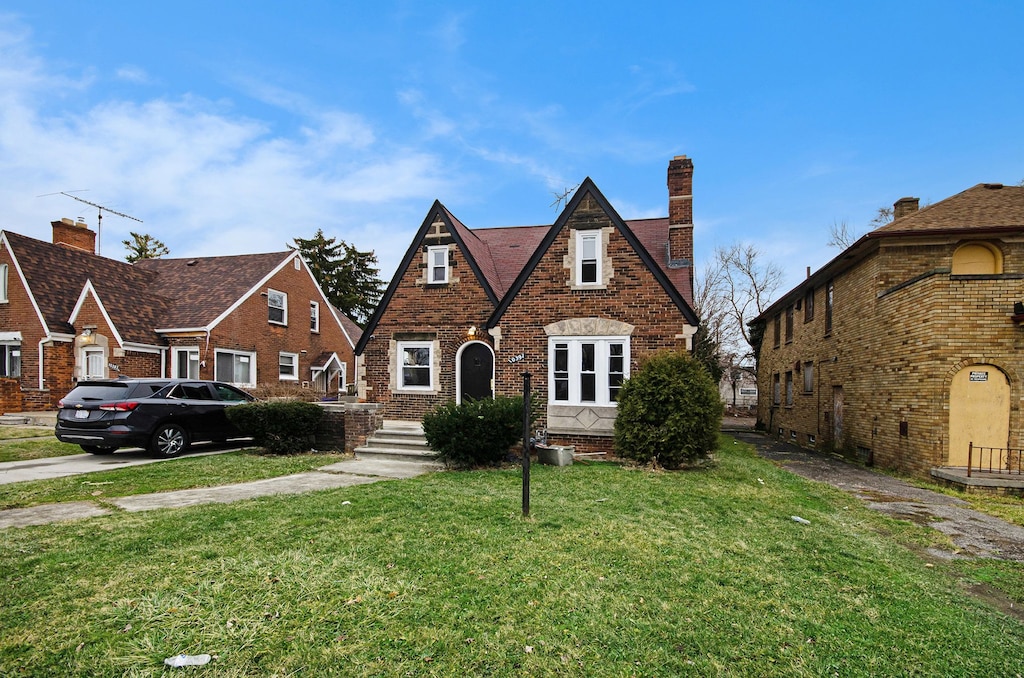 english style home with a front lawn