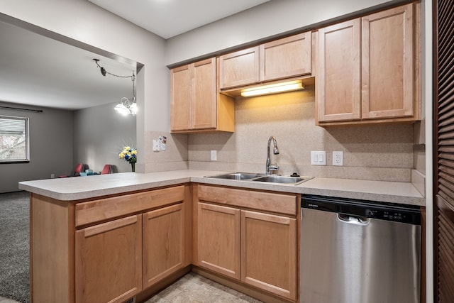 kitchen with light brown cabinetry, sink, hanging light fixtures, stainless steel dishwasher, and kitchen peninsula