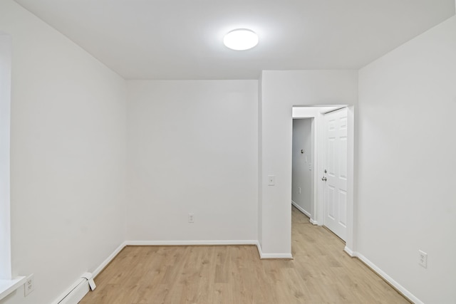 spare room with light hardwood / wood-style floors and a baseboard radiator