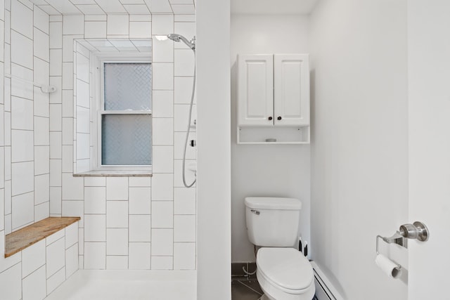 bathroom featuring a tile shower, a baseboard radiator, toilet, and tile patterned floors