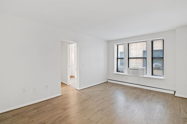 unfurnished room featuring baseboard heating, light hardwood / wood-style flooring, and cooling unit