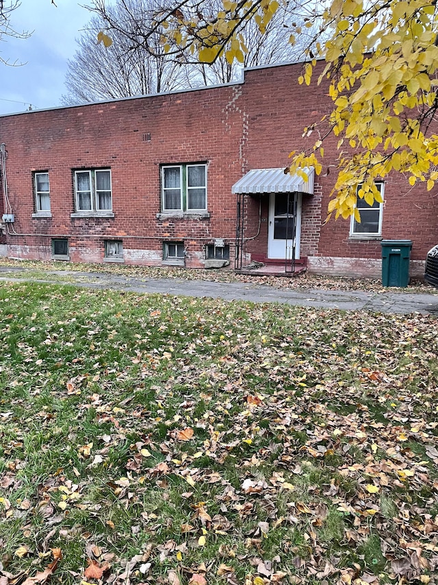rear view of property with brick siding