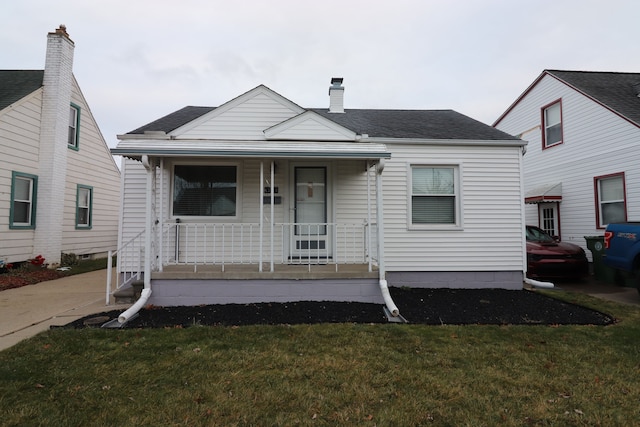 bungalow with a front yard and a porch