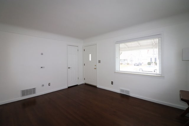 empty room with dark wood-type flooring