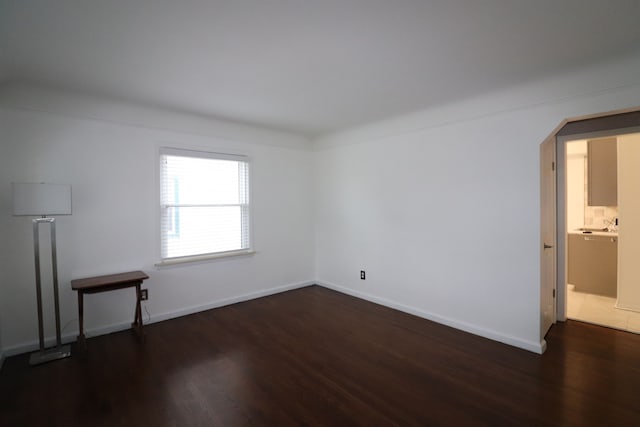 spare room featuring dark hardwood / wood-style floors