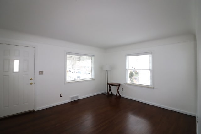 entryway with dark hardwood / wood-style floors