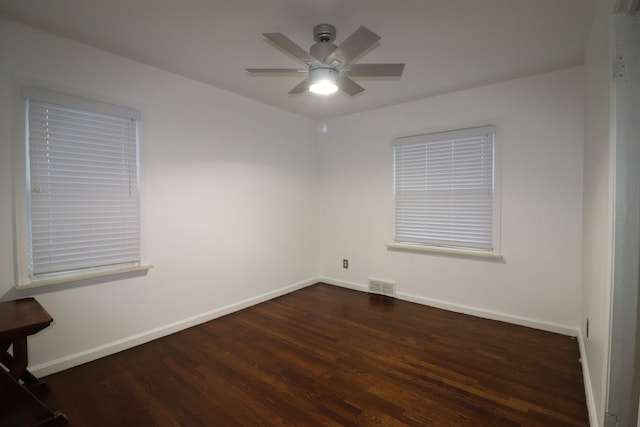 empty room with ceiling fan and dark wood-type flooring