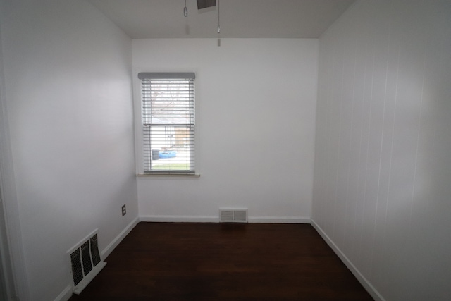 unfurnished room with dark hardwood / wood-style flooring