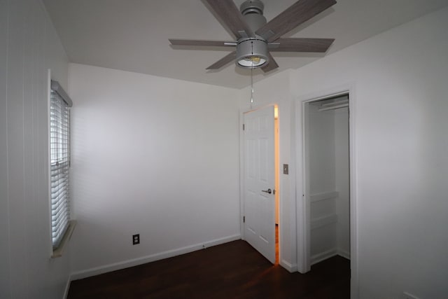 unfurnished bedroom featuring multiple windows, ceiling fan, a closet, and dark hardwood / wood-style floors