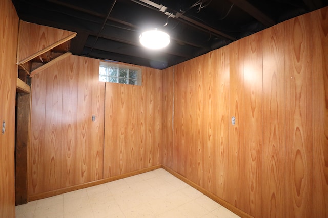 basement with elevator and wood walls