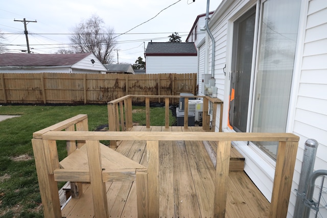 wooden deck with central air condition unit and a yard