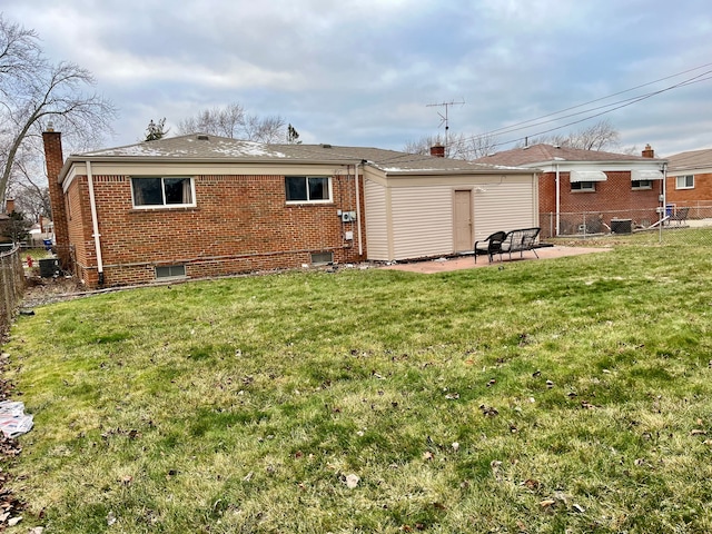 back of property featuring a patio area and a yard