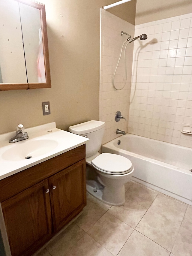 full bathroom featuring tile patterned flooring, vanity, toilet, and tiled shower / bath