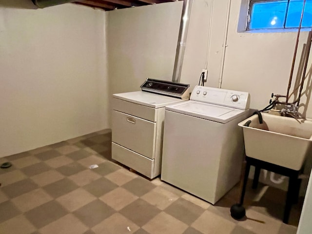 washroom with washing machine and clothes dryer and sink