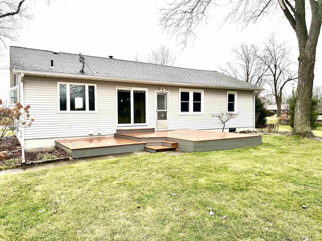 rear view of property with a deck and a lawn