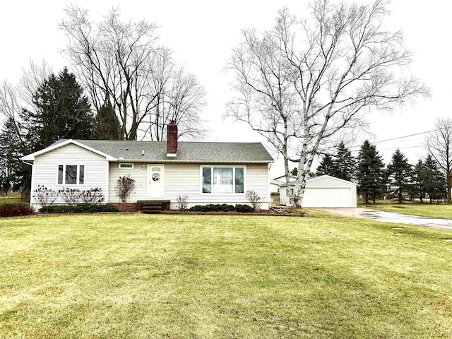 view of front facade featuring an outbuilding, a garage, and a front lawn