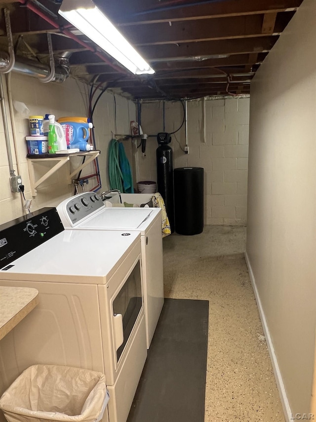 clothes washing area with washing machine and clothes dryer