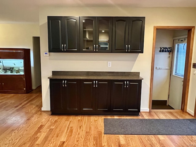 bar with light hardwood / wood-style floors