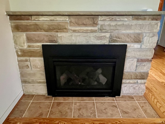 interior details with a stone fireplace