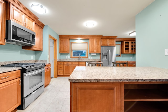 kitchen featuring appliances with stainless steel finishes, a center island, and sink