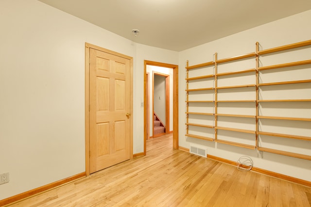 spare room featuring light hardwood / wood-style flooring