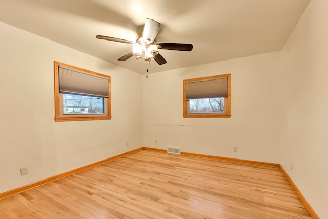 spare room featuring ceiling fan and light hardwood / wood-style flooring