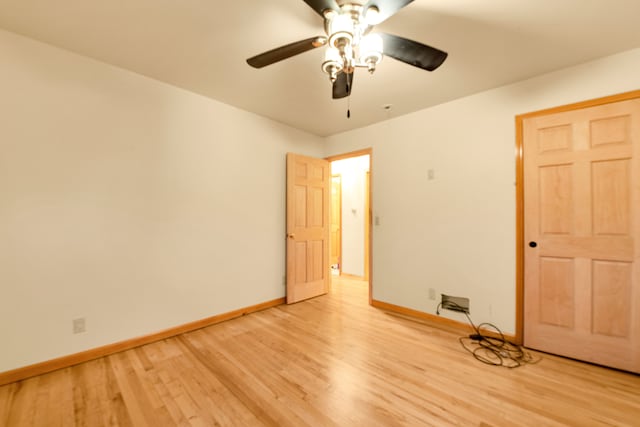 unfurnished bedroom with ceiling fan and light wood-type flooring