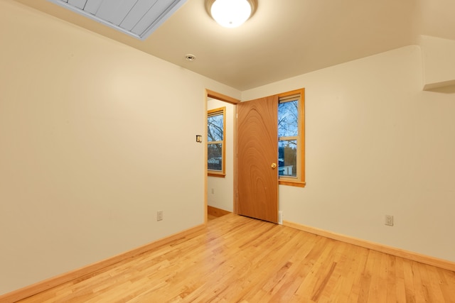 spare room with light hardwood / wood-style flooring