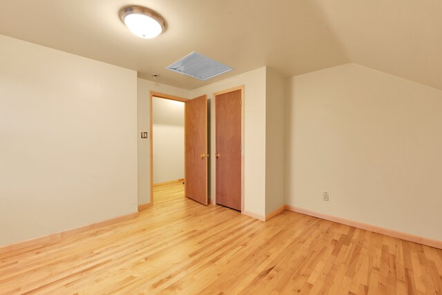 bonus room featuring light hardwood / wood-style floors and vaulted ceiling