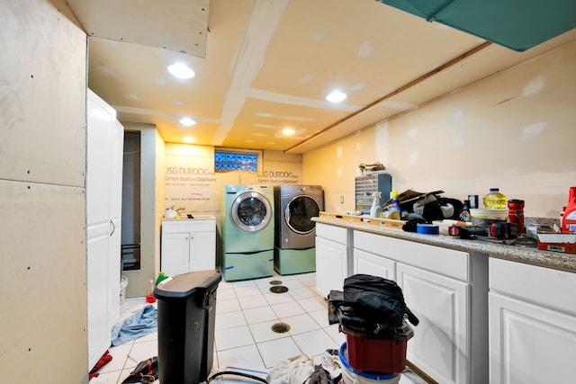 clothes washing area with independent washer and dryer and light tile patterned floors