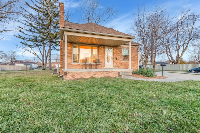 view of front of home featuring covered porch and a front yard