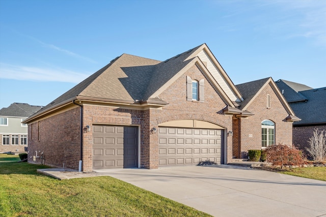 view of front of house featuring a garage and a front lawn