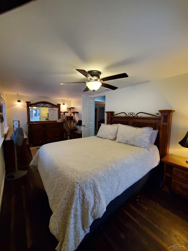 bedroom with dark hardwood / wood-style floors and ceiling fan