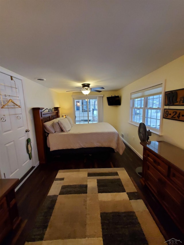 bedroom with baseboards, a ceiling fan, and wood finished floors