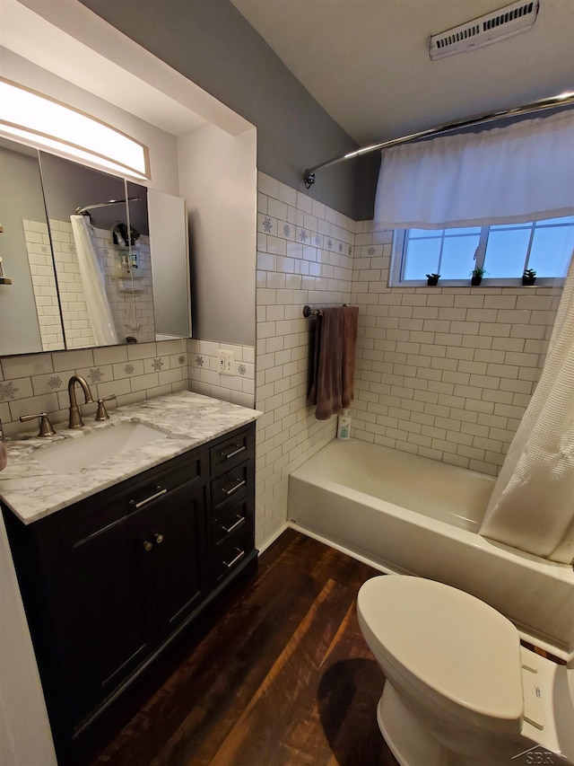 bathroom with wood finished floors, vanity, visible vents, tasteful backsplash, and shower / bath combo with shower curtain