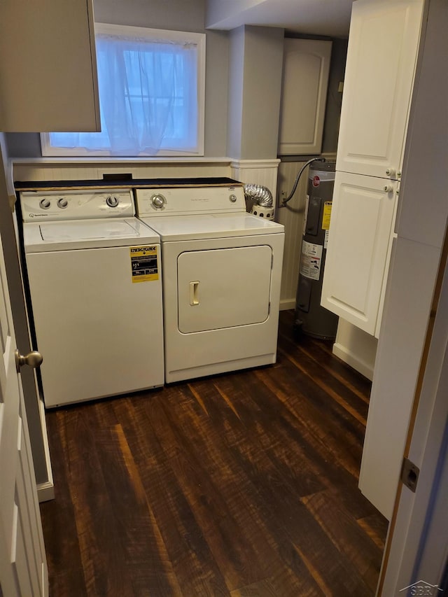 laundry room featuring cabinet space, water heater, separate washer and dryer, and dark wood finished floors